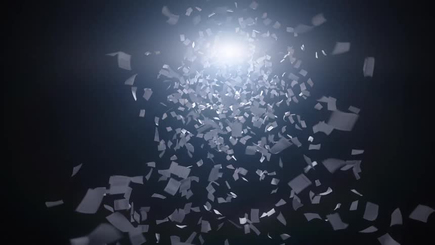 Countless white paper documents swirl in a slow-motion vortex, illuminated by a bright light against a dark background