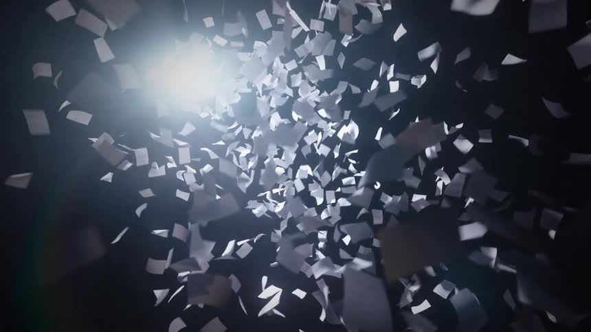 A chaotic swirl of white paper sheets floats through a dark void illuminated by a bright light source