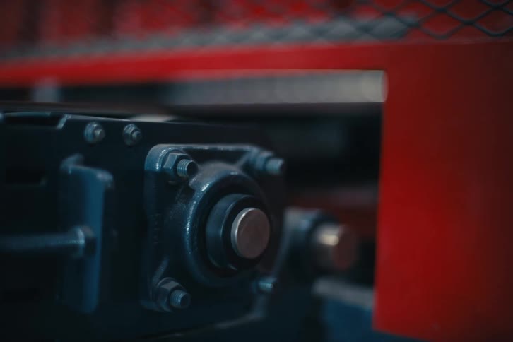 A close-up shot of a rotating industrial machine part in a factory