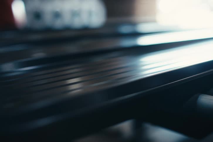 Close-up shot of an automated conveyor belt moving along a production line in a manufacturing factory