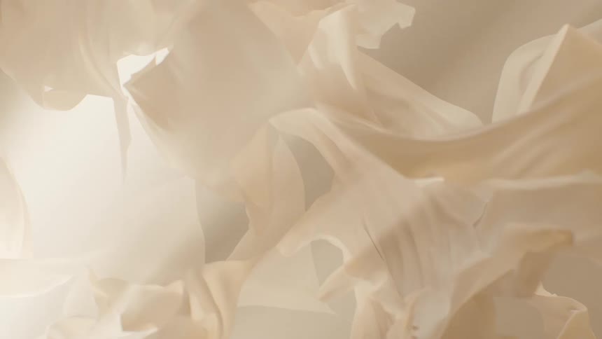 Soft, translucent beige fabric gently billows and floats in a dreamy, abstract slow-motion background