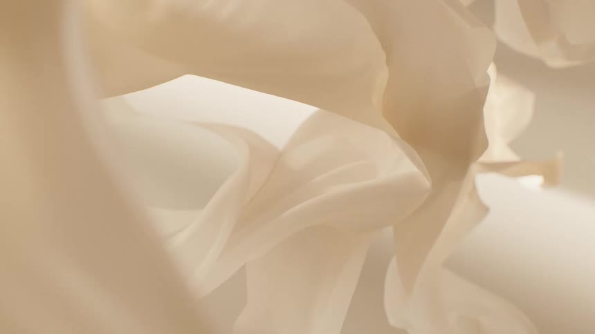 Delicate layers of soft, beige fabric or paper create a dreamy, abstract and minimalist background with subtle movement