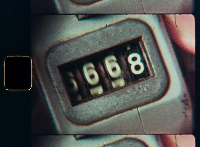 A vintage analog counter rapidly resets back to zero in a macro shot on authentic 8mm film