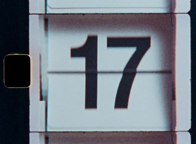 A vintage flip calendar with a film grain texture counts up through the days of the month in a continuous loop