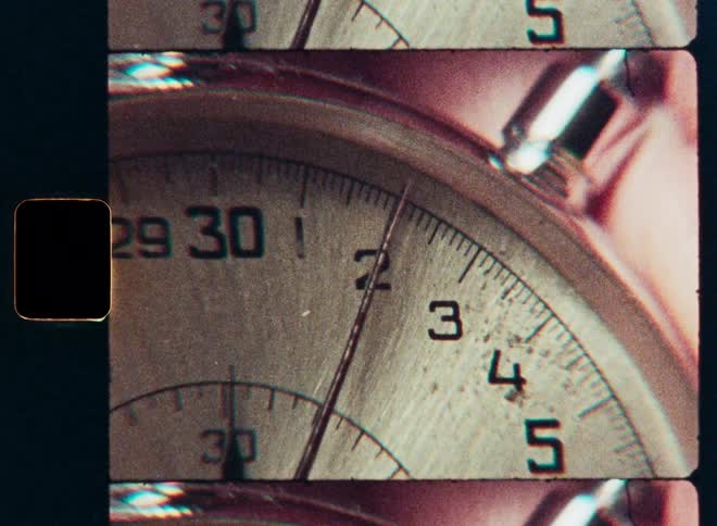A vintage film strip effect shows a macro close-up of a stopwatch as the second hand ticks forward