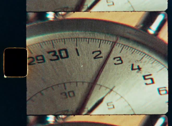 A gritty, vintage film-style macro shot of a stopwatch needle ticking away the seconds