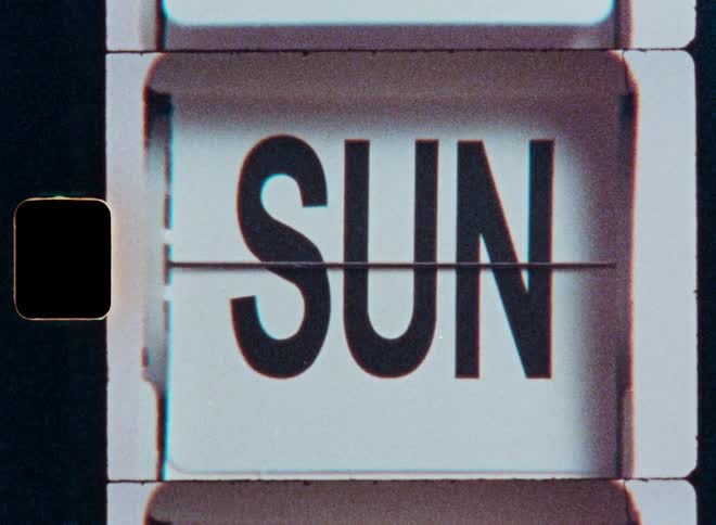 A vintage flip calendar rapidly cycles through the days of the week in a grainy, film-style stop-motion animation