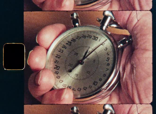A vintage film strip shows a close-up of a person's hand holding a running stopwatch as time passes