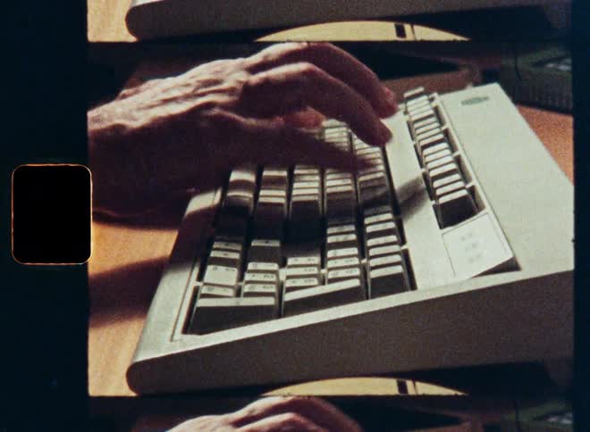 A vintage film strip scan shows a close-up of hands typing on a retro computer keyboard from the 80s or 90s