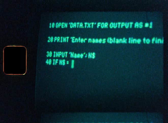 A close-up of a programmer coding in the BASIC language on a vintage monochrome computer screen with a Super 8 film aesthetic