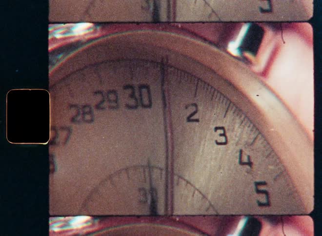 A gritty close-up shot of a vintage stopwatch's second hand ticking, captured on authentic super 8 film with sprocket holes and light leaks