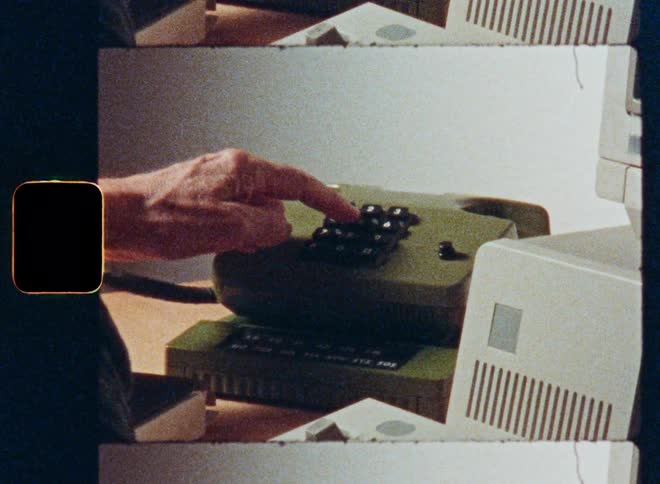 Archival footage shows a person typing on a vintage computer and dialing a number on an old landline phone