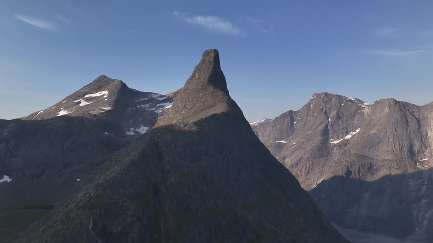A stunning timelapse captures the sun moving across the iconic, sharp peak of Romsdalshorn mountain in Norway's rugged landscape