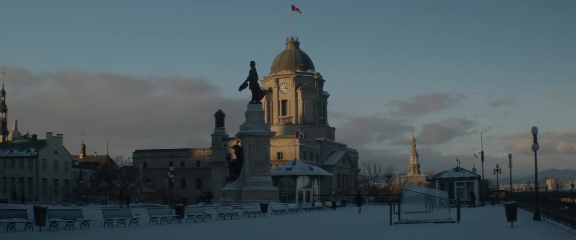 Golden hour sunlight illuminates the historic Bonsecours Market and Cartier Monument in a snow-covered Place Jacques-Cartier in Old Montreal