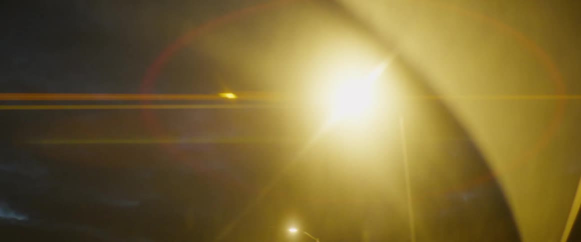 Dreamy abstract lens flare from a bright streetlight glowing in the dark night