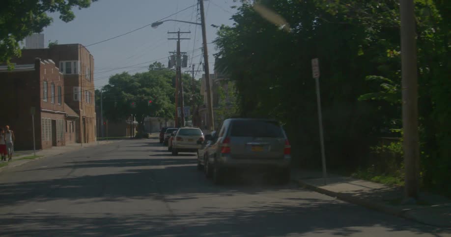 The street is empty besides two people walking