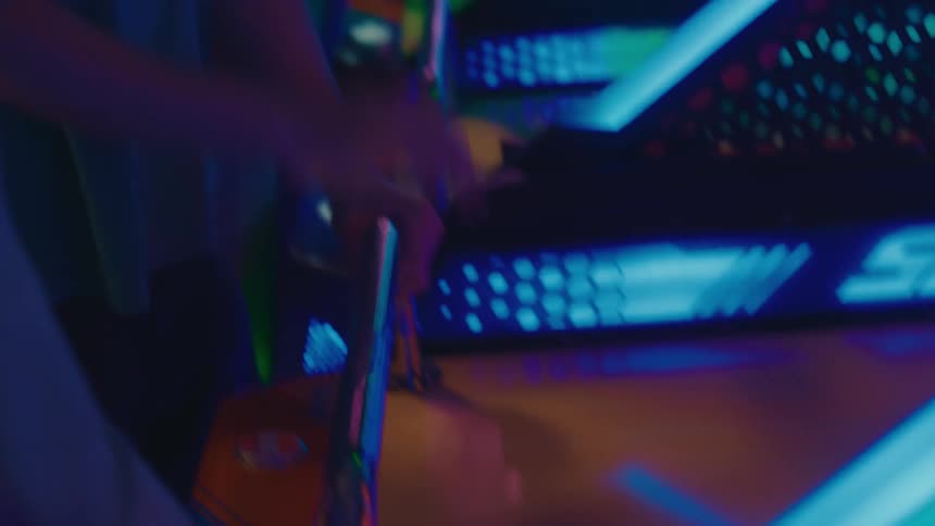 A group of diverse friends enjoys a night of fun playing a neon-lit basketball arcade game