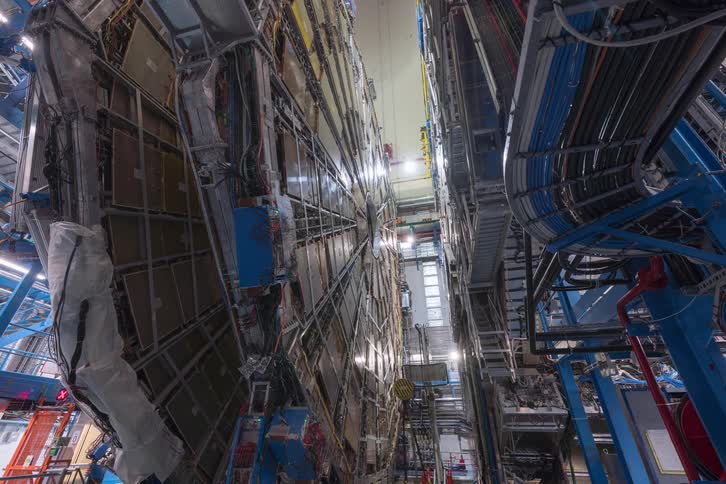 A fascinating timelapse captures engineers working diligently on the massive and complex machinery of a particle accelerator in a state-of-the-art laboratory