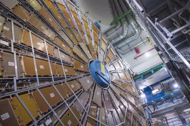 A dizzying upward pan reveals the immense and complex inner workings of a particle detector at a scientific research facility