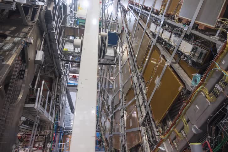 A vertical timelapse reveals the immense scale and intricate machinery of a particle accelerator at a research facility