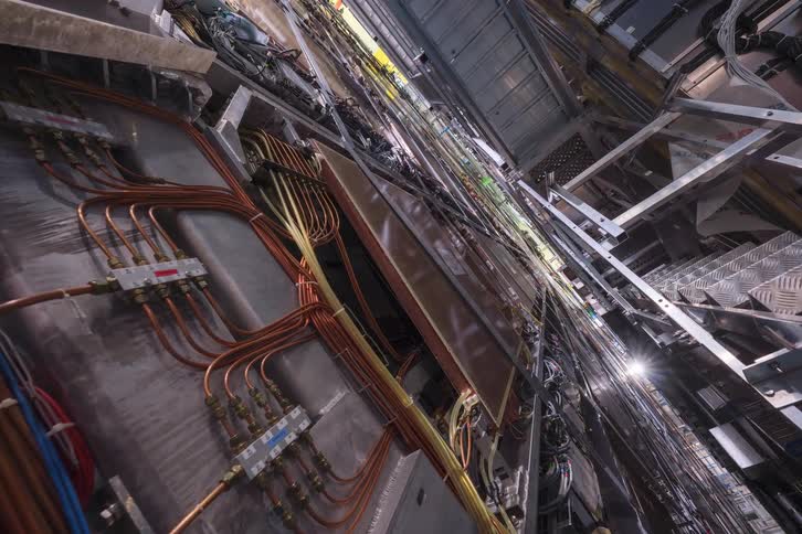 A slow zoom-out reveals the incredibly complex wiring and components inside a massive particle accelerator