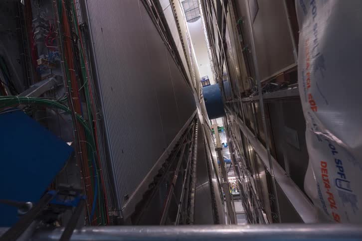 A high-angle timelapse slowly descends, revealing the vast and complex machinery inside a particle accelerator
