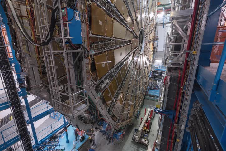 Timelapse of engineers and scientists working on a massive particle detector at a cutting-edge research facility