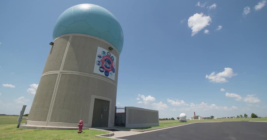 Time-lapse of clouds passing over the National Weather Radar Testbed building on a sunny day