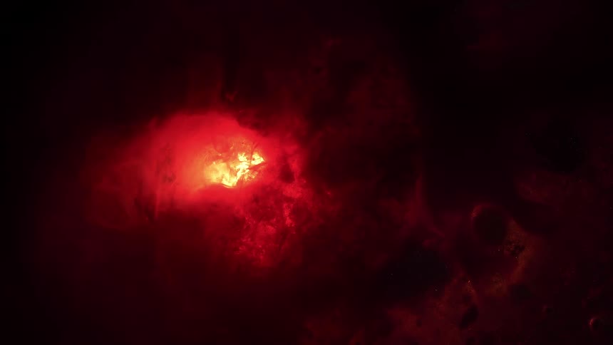 The glowing, fiery core of a deep red nebula pulsates in the darkness of outer space