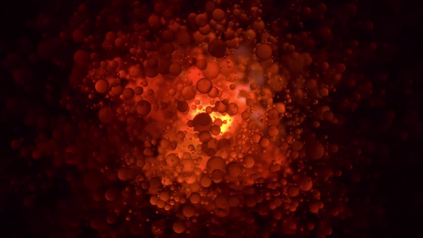 Fiery red and orange orbs slowly swirl and pulsate around a glowing central light source
