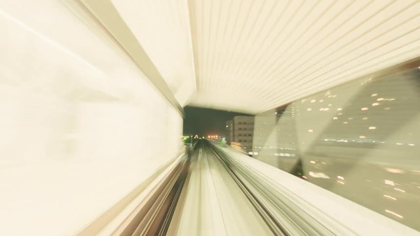 A futuristic point-of-view time-lapse of a high-speed train journey through an illuminated cityscape at night
