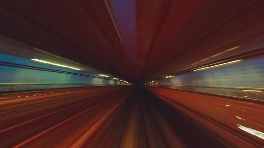 A futuristic point-of-view time-lapse of a high-speed train journey through the illuminated cityscape of Tokyo at night