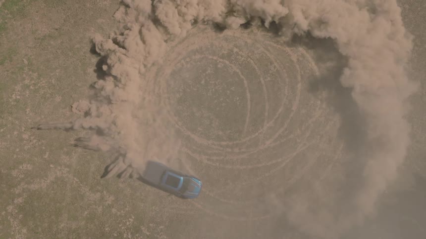 A slow-motion, top-down aerial view shows a blue pickup truck kicking up a massive cloud of dust while doing donuts in a dry, grassy field