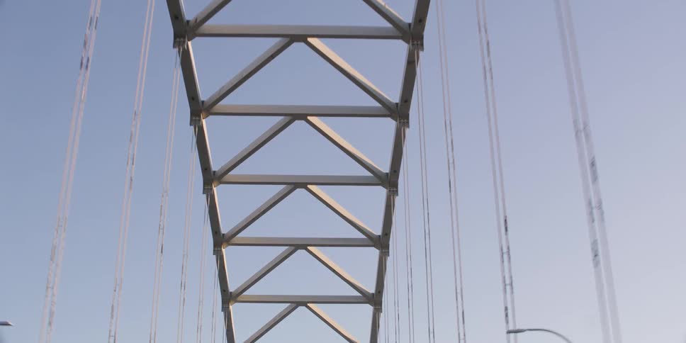 A point-of-view shot from a car driving towards and under the Fremont Bridge in Portland, Oregon, on a sunny day