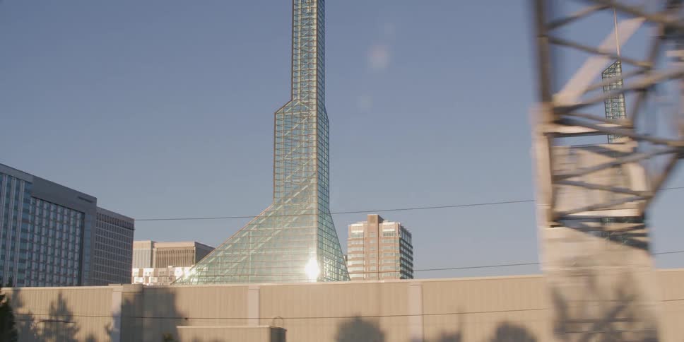 Slow motion driving shot reveals the twin glass towers of the Oregon Convention Center on a sunny day