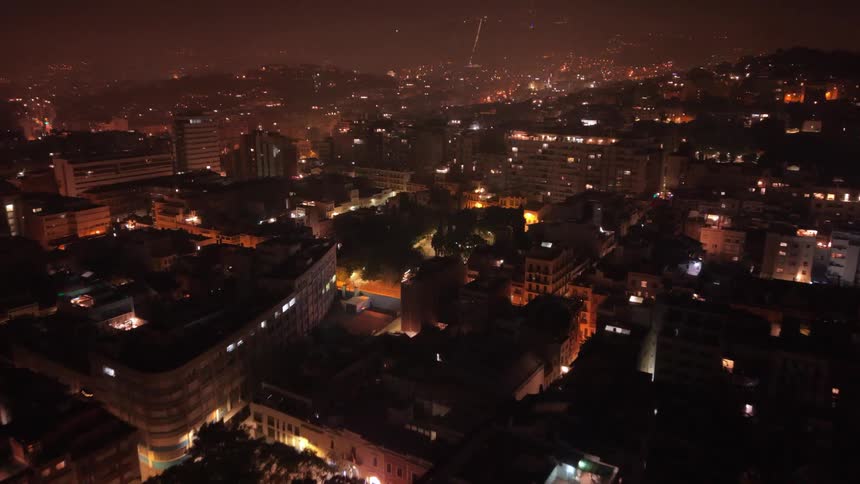 Festive fireworks explode over a city at night in a brilliant aerial display