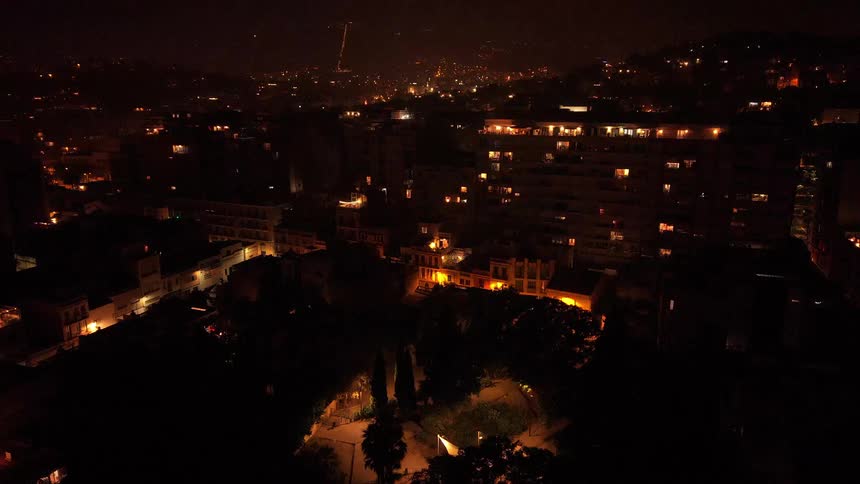 Stunning aerial time-lapse captures the flickering lights of a bustling city throughout the night