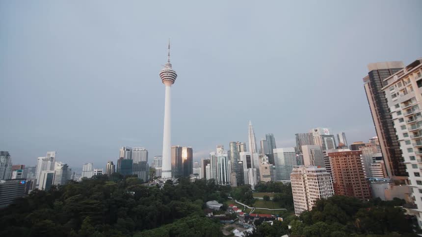 A spy-like view through a peephole reveals the Kuala Lumpur, Malaysia skyline with the iconic Menara KL tower at the center