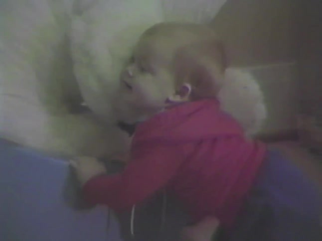 Vintage home video footage with VHS distortion shows a cute baby playing with a giant teddy bear inside a toy car in their nursery