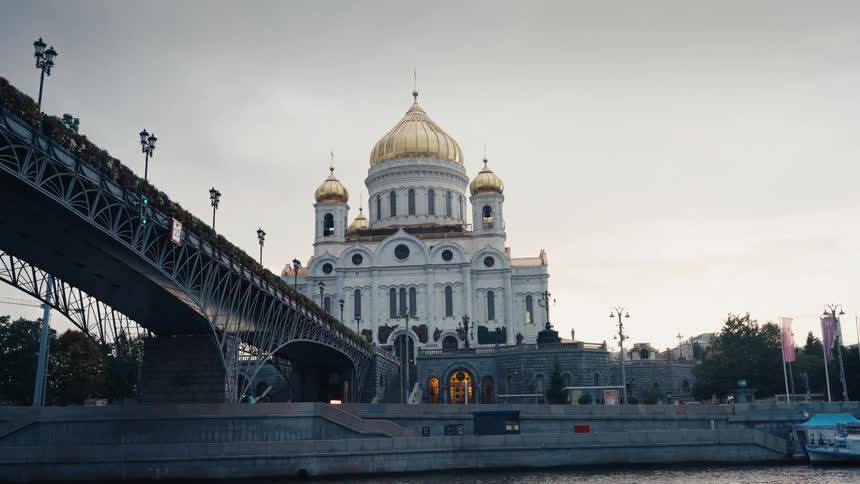 A majestic slow-moving reveal of the Cathedral of Christ the Saviour in Moscow, filmed from the Moskva River next to the Patriarshy Bridge
