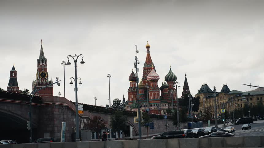 A slow-moving view from a river reveals the iconic St. Basil's Cathedral and the Kremlin in Moscow on a cloudy day