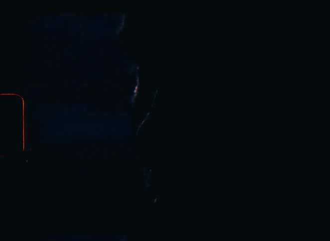 A grainy, dark vintage film with light leaks shows the silhouette of a person in rippling water