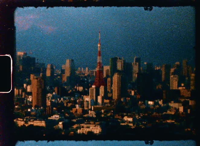 Vintage 8mm footage of the expansive Tokyo skyline featuring the iconic Tokyo Tower at sunset