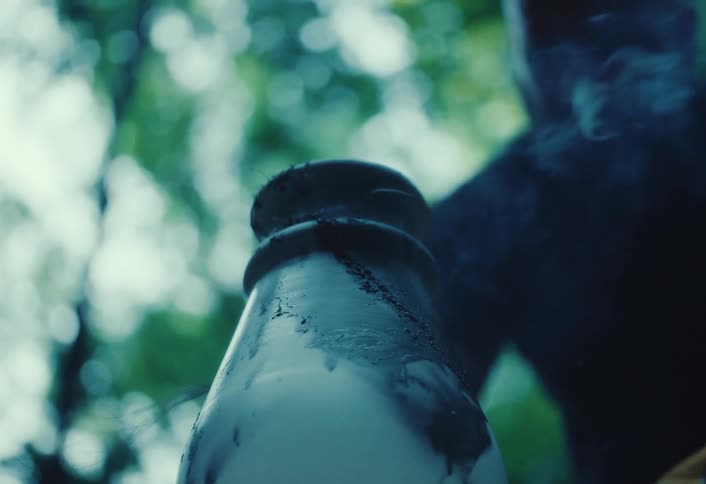 Slow motion close-up of smoke billowing from a freshly fired raku ceramic piece outdoors