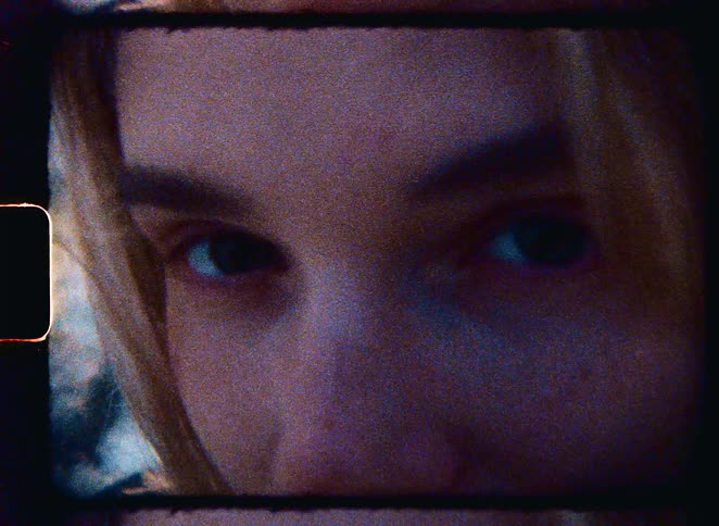 A grainy and intimate 8mm film captures the melancholic and thoughtful gaze of a young woman's eyes