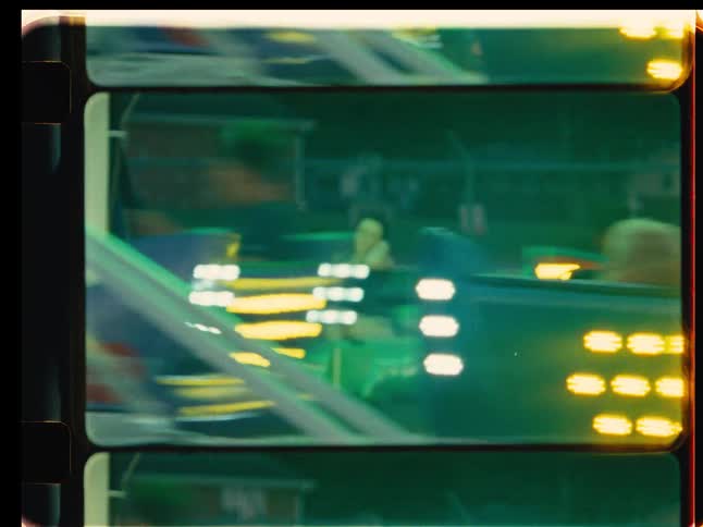 A vintage film captures the dizzying fun of people on a fast-spinning carnival ride at night