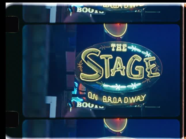 Vintage super 8 film footage captures close-ups of glowing neon signs for Broadway music venues and honky tonk bars at night