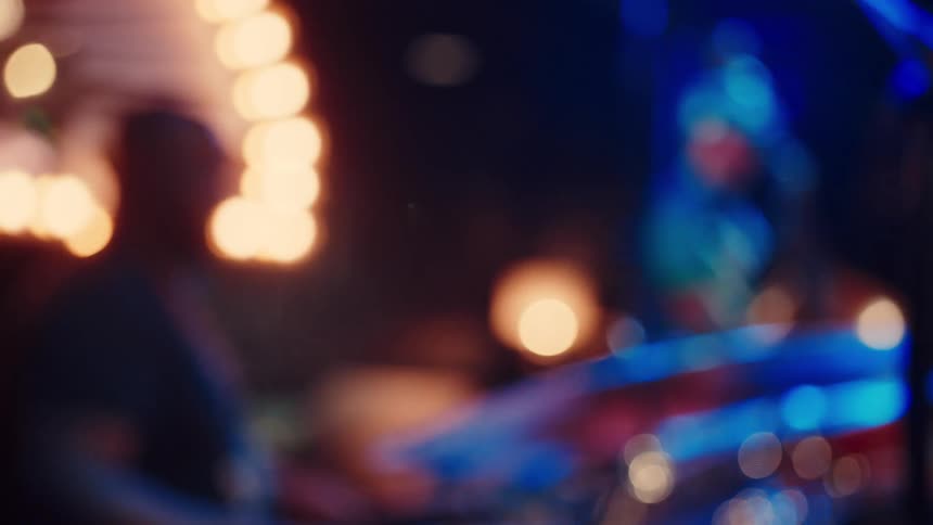 Bokeh background of a music band performing a live show in a dark, atmospheric venue