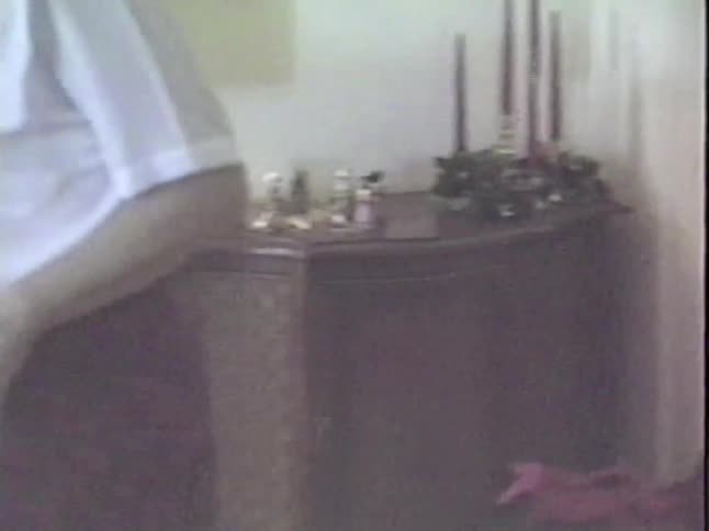 A home video from the 1980s shows Christmas decorations and a touching hug between two female family members