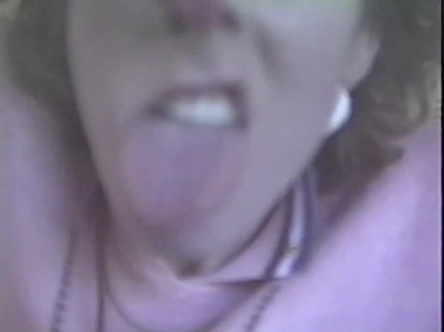 Vintage VHS footage shows a playful young woman with 80s style making a series of goofy faces for the home video camera